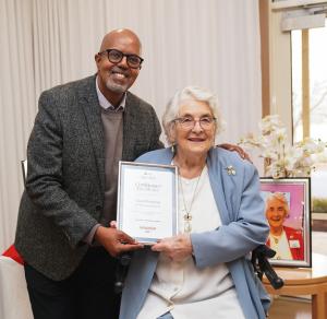 Ageing Australia General Manager Marketing & Communications Abderazzaq Noor presenting Carol with her award on Aged Care Employee Day 7 August 2025.